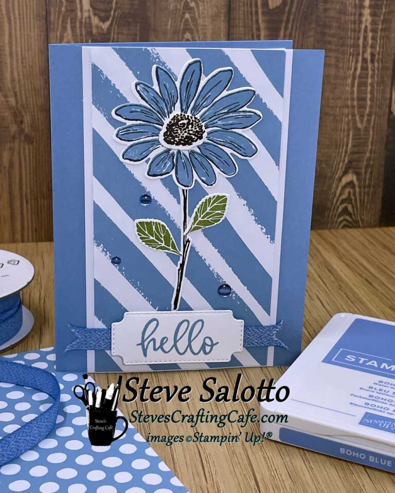 A greeting card with a blue daisy on it that says "hello"