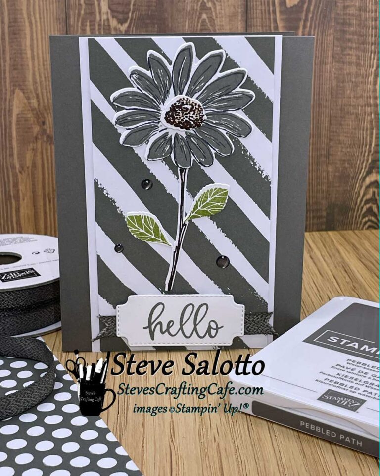 A greeting card with a gray daisy on it that says "hello"