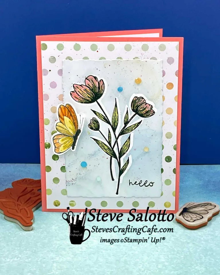 A yellow and orange butterfly hovers near pink flowers on a handmade greeting card that says, "hello."