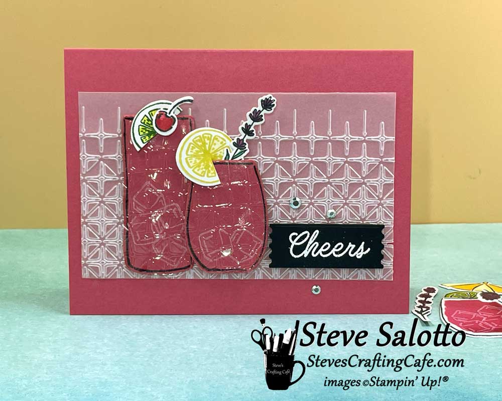 A pink card with two cocktails on it and the sentiment, "Cheers"