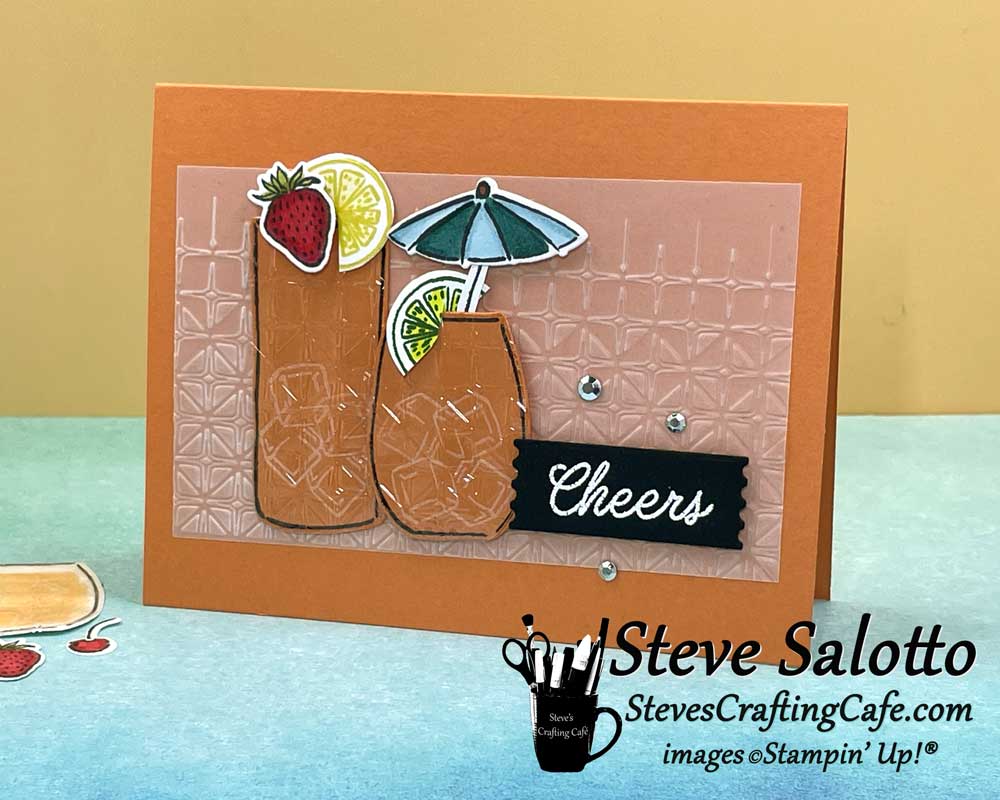 An orange card with two cocktails on it and the sentiment, "Cheers"