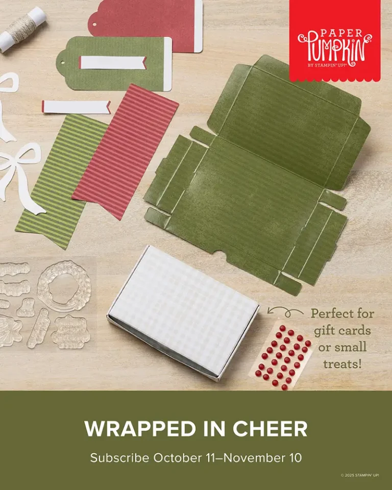 A green unassembled box with red and green tags, stamps, and wording that reads, "Wrapped in Cheer. Subscribe October 11- November 10."