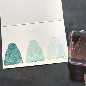 Three beanie images are stamped onto white card stock, getting progressively lighter.