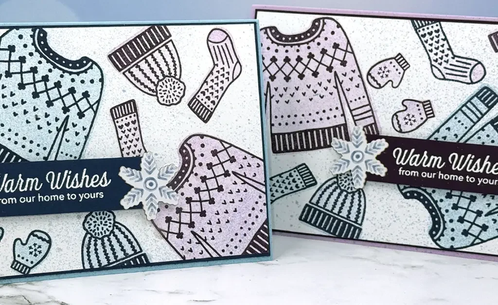 2 greeting cards with stamped images of sweaters, hats, socks and mittens. Sentiments read, "Warm Wishes from our home to yours."