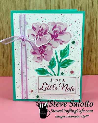 A greeting card with ink blended purple flowers on it and the sentiment, "Just a Little Note."